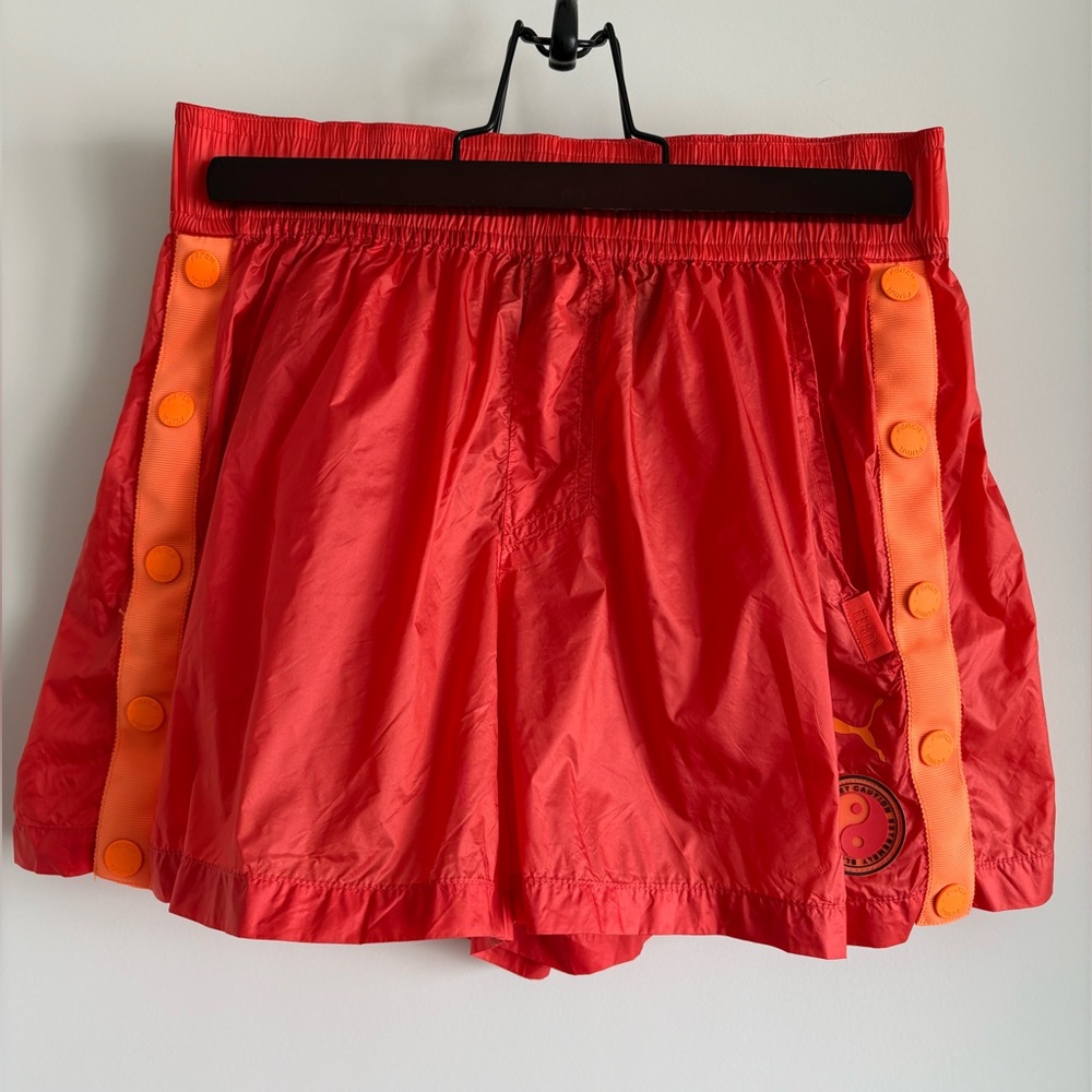 Fenty x Puma orange athletic shorts.